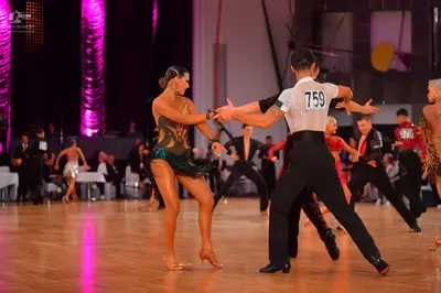 Dancesport competitor #759, #579: Male dancer 759: white short-sleeved shirt and black trousers