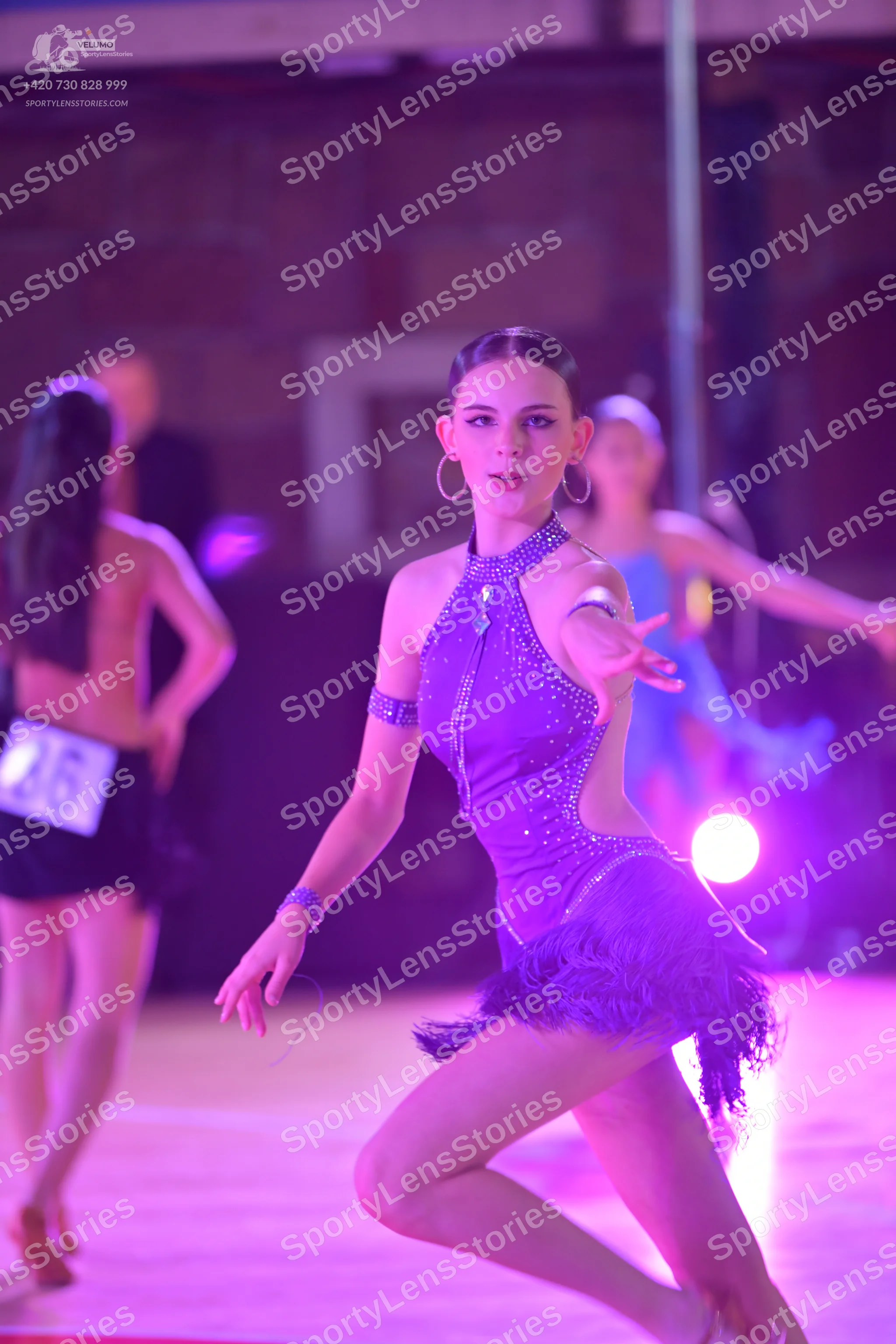 Dancesport competitor: ** Deep purple, fitted latin dress
