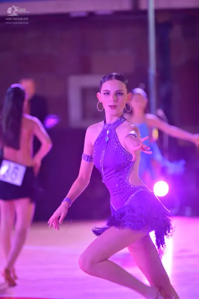 Dancesport competitor: ** Deep purple, fitted latin dress