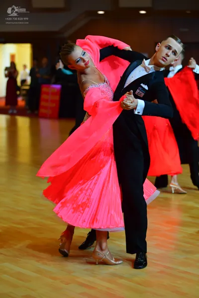 Dancesport competitor: Male dancer: black suit with a white shirt