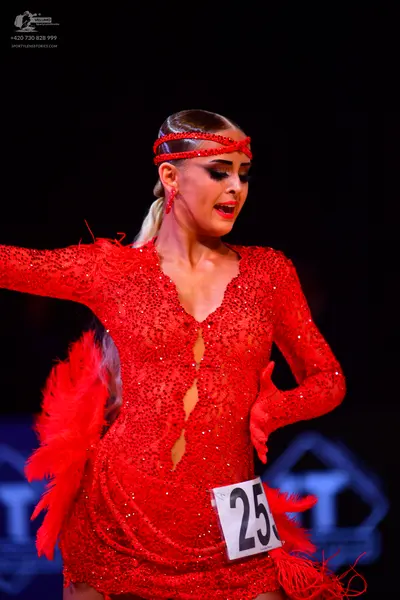Dancesport competitor: Female dancer: red latin dress with sequins and feather/fringe details, red sequ