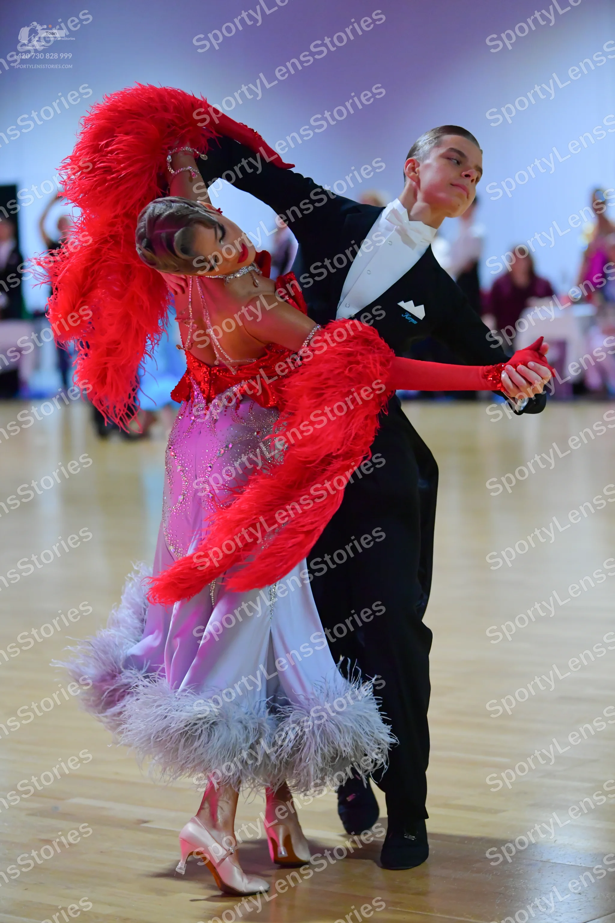 Dancesport competitor: Male dancer: black suit with a white shirt and white bowtie