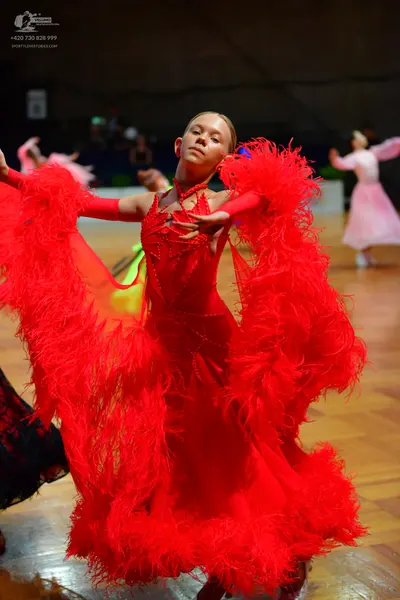 Dancesport competitor: Main dancer: red Latin dress with large red feather embellishments