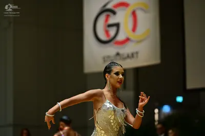 Dancesport competitor: Female dancer: silver latin dress with sequin embellishments and thin hanging st