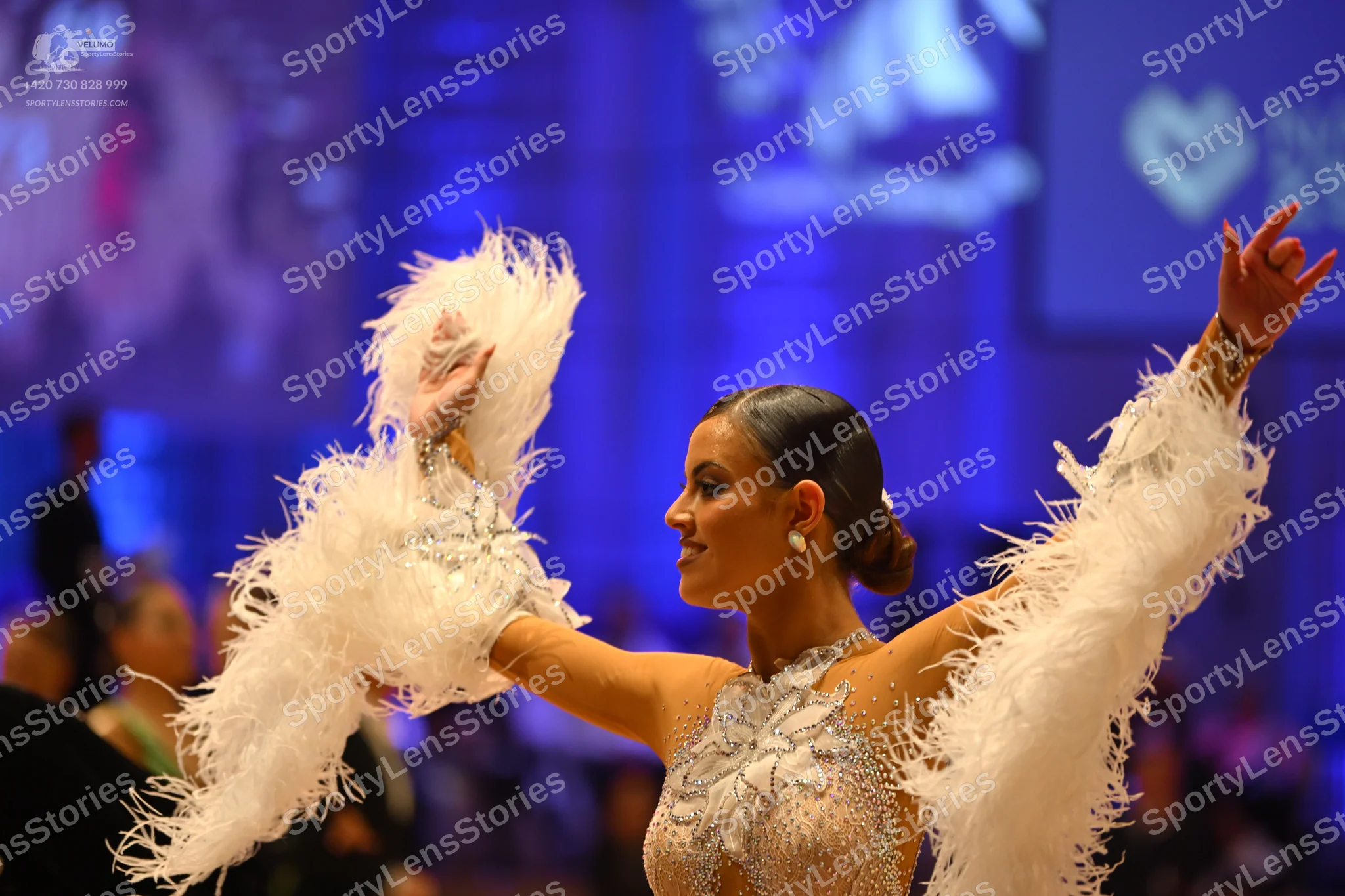 Dancesport competitor: Female dancer: white Latin dress with extensive sequin/beaded embellishments and