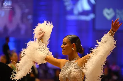 Dancesport competitor: Female dancer: white Latin dress with extensive sequin/beaded embellishments and