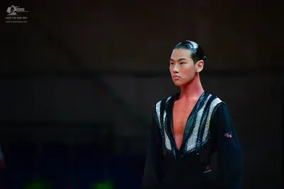 Dancesport competitor: Male dancer: black Latin top with large silver sequined panels on the chest