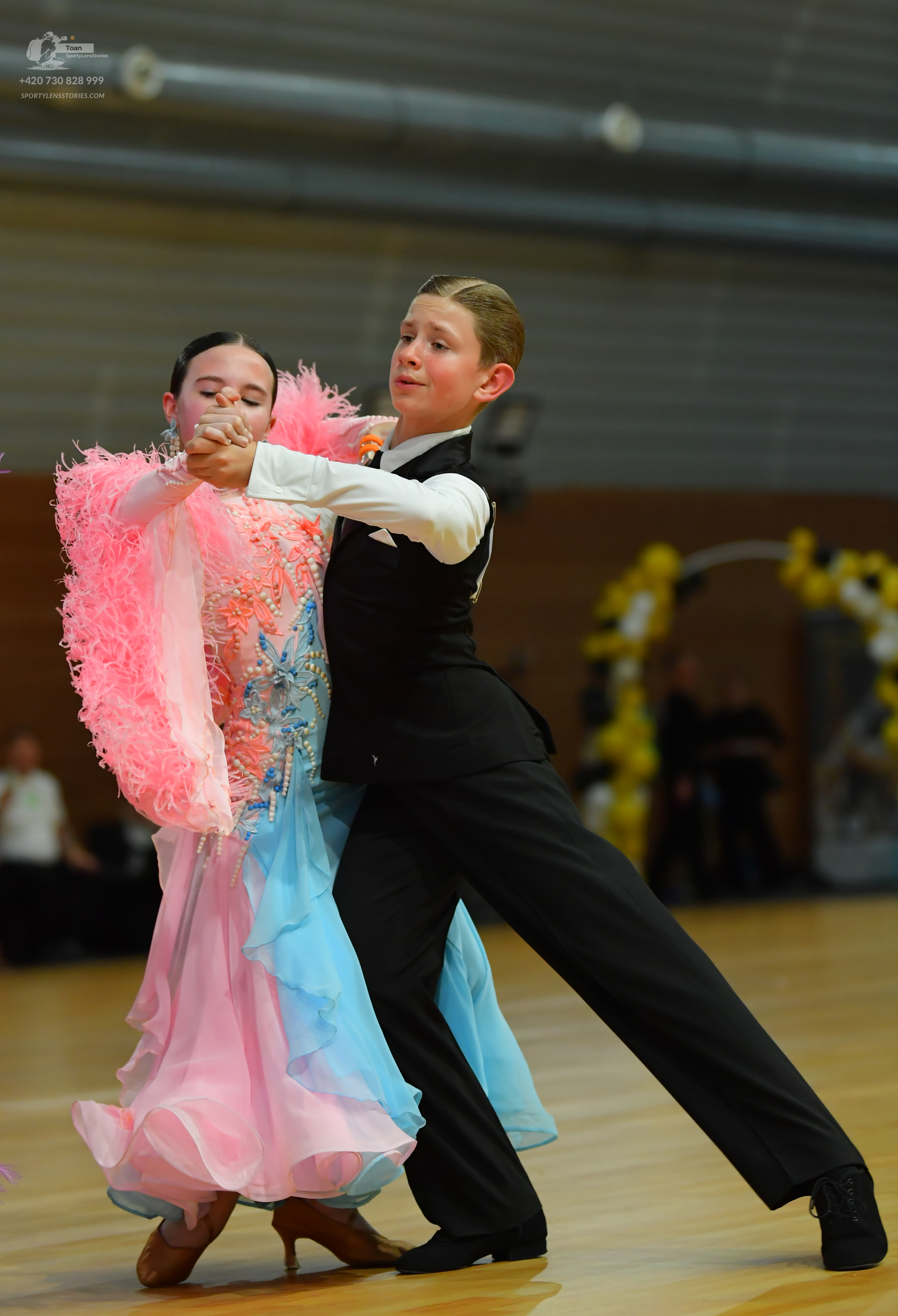 Dancesport competitor: ** Black tailsuit
*   **Fabric:** Satin
*   **Details:** The suit has sequin lap