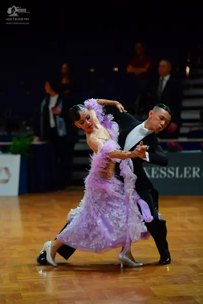 Dancesport competitor: Male dancer: black suit with a white shirt