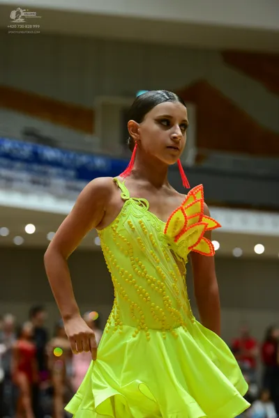 Dancesport competitor: ** Female: Yellow (bright, almost neon) satin dress with a ruffled, voluminous s