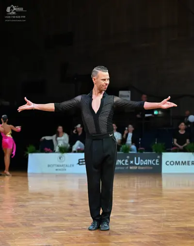 Dancesport competitor: Male dancer: black long-sleeved shirt with sheer mesh fabric on the chest and ar