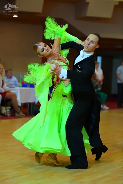 Dancesport competitor: Male dancer: black suit with a white shirt and white bowtie