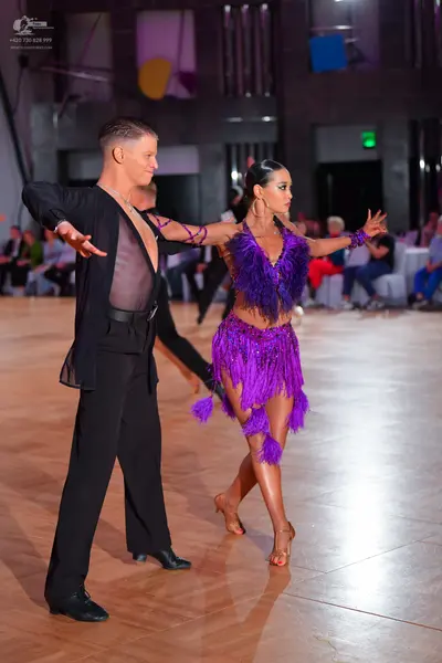 Dancesport competitor: Male dancer: black shirt with a sheer mesh panel on the chest and black trousers