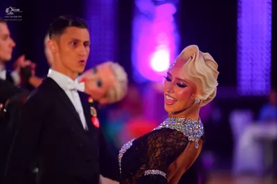 Dancesport competitor: Male dancer: black suit with a white shirt and white bow tie