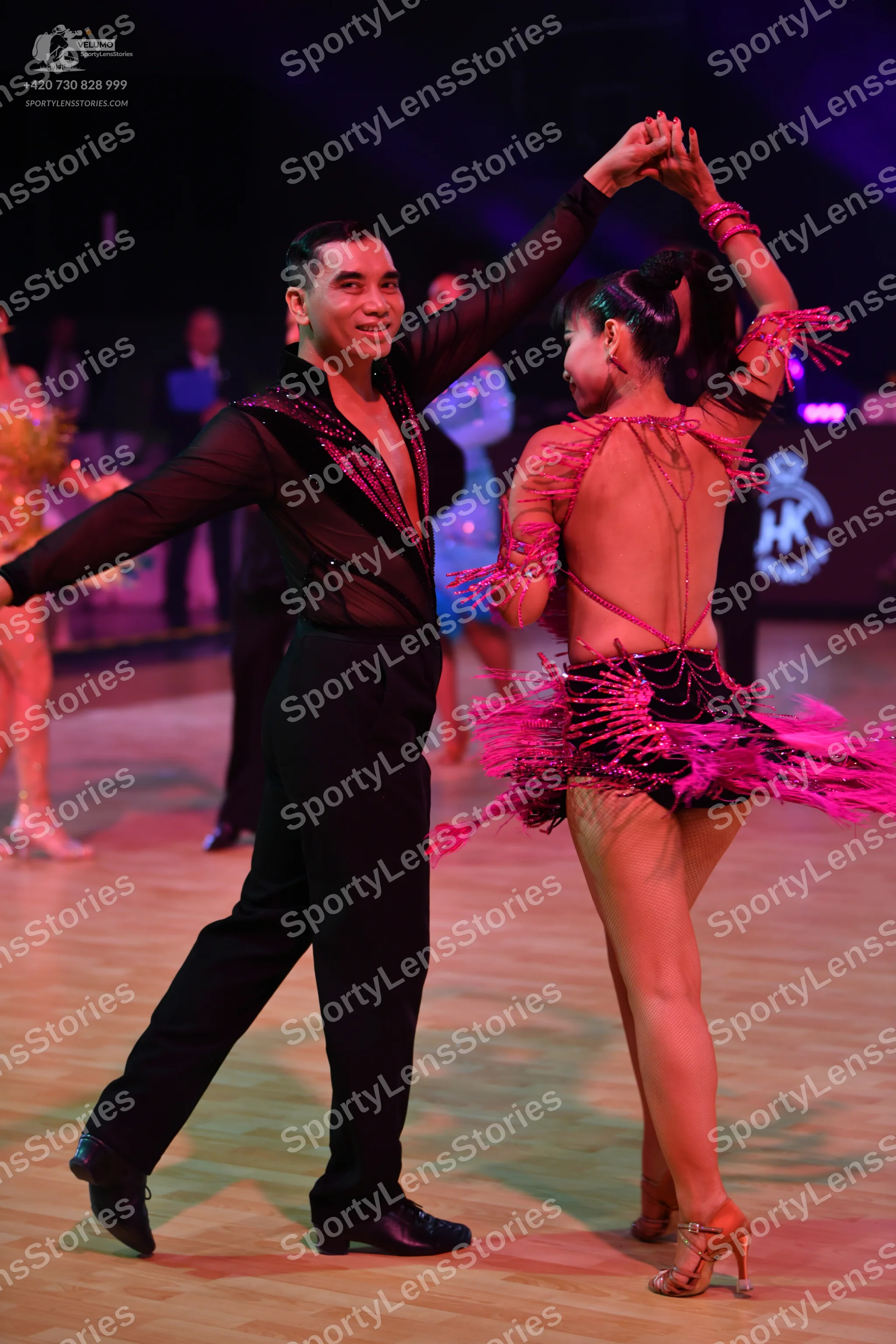 Dancesport competitor: Male dancer: black long-sleeved Latin dance shirt with sequin trim on the neckli