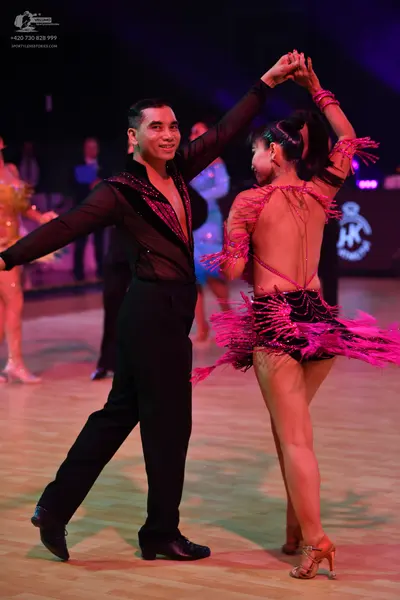 Dancesport competitor: Male dancer: black long-sleeved Latin dance shirt with sequin trim on the neckli
