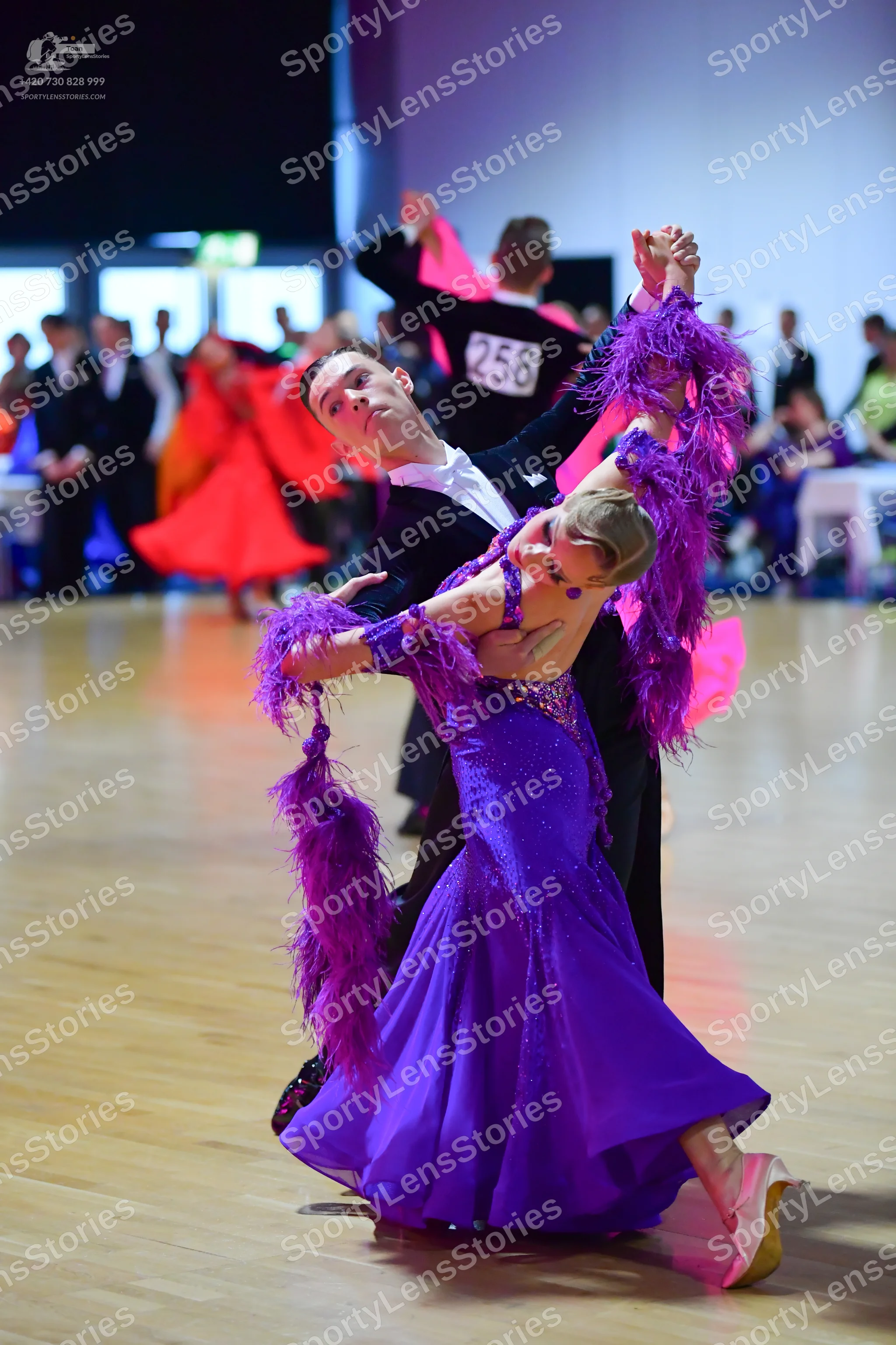 Dancesport competitor #258: Male dancer in foreground: black suit with white shirt