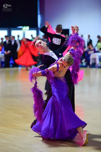 Dancesport competitor #258: Male dancer in foreground: black suit with white shirt