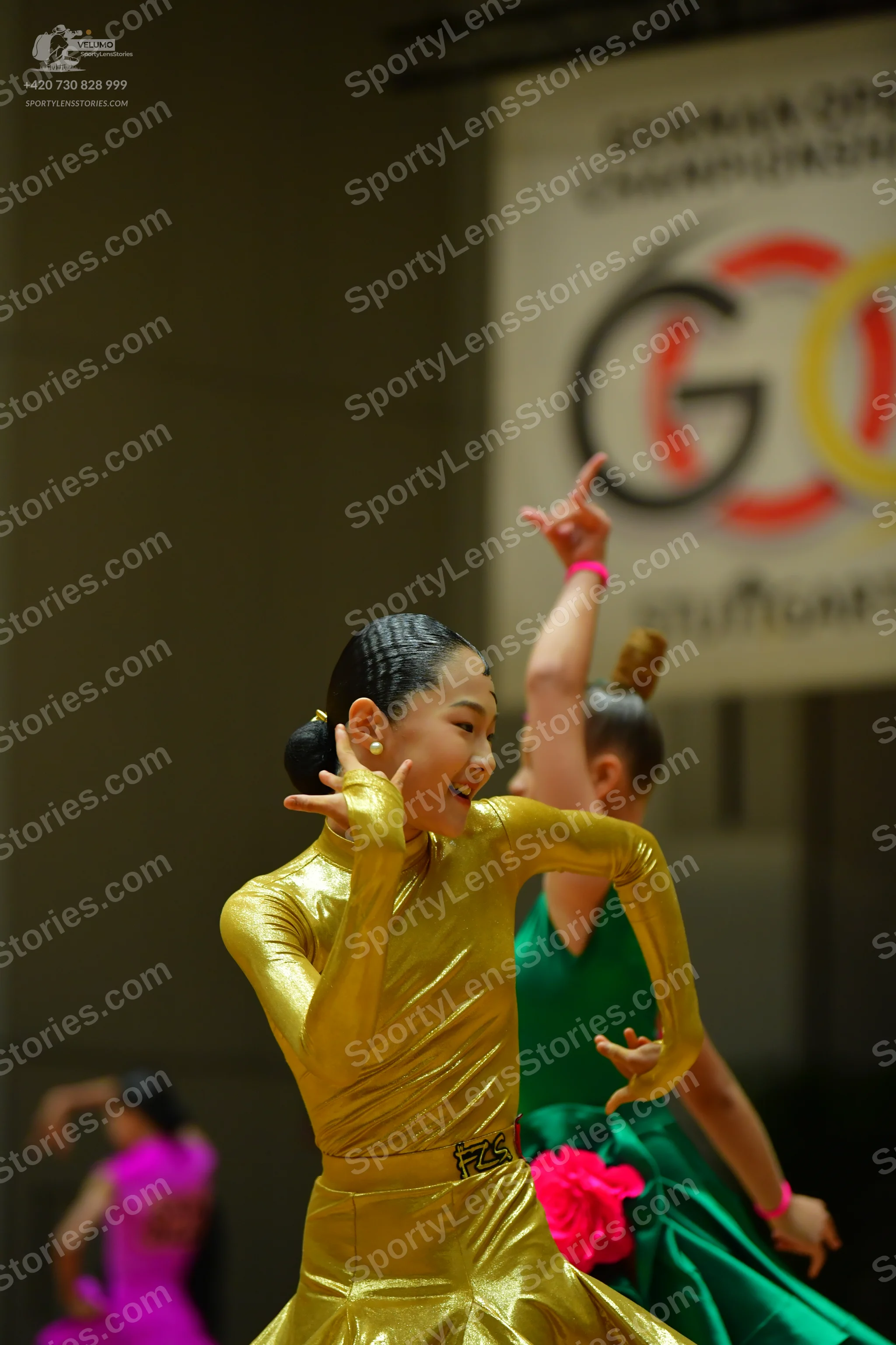 Dancesport competitor #73: Female dancer 1: gold metallic long-sleeved dress