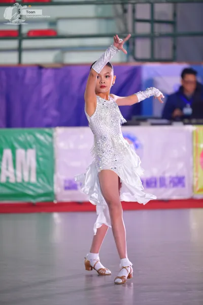 Dancesport competitor: ** White, shimmering, bodycon Latin dress