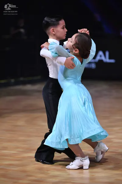 Dancesport competitor: Male dancer: white long-sleeved shirt and black trousers