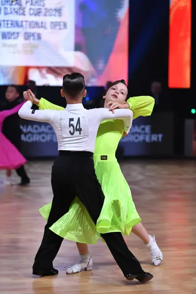 Dancesport competitor: Male dancer: white long-sleeved shirt and black trousers
