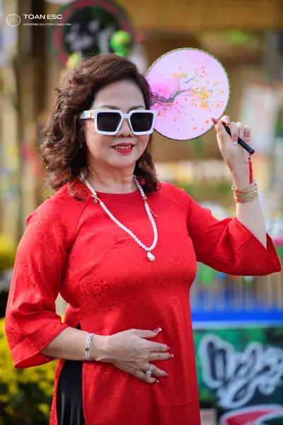 Dancesport competitor: Female dancer: red long-sleeved top with a patterned fabric, white pearl necklac