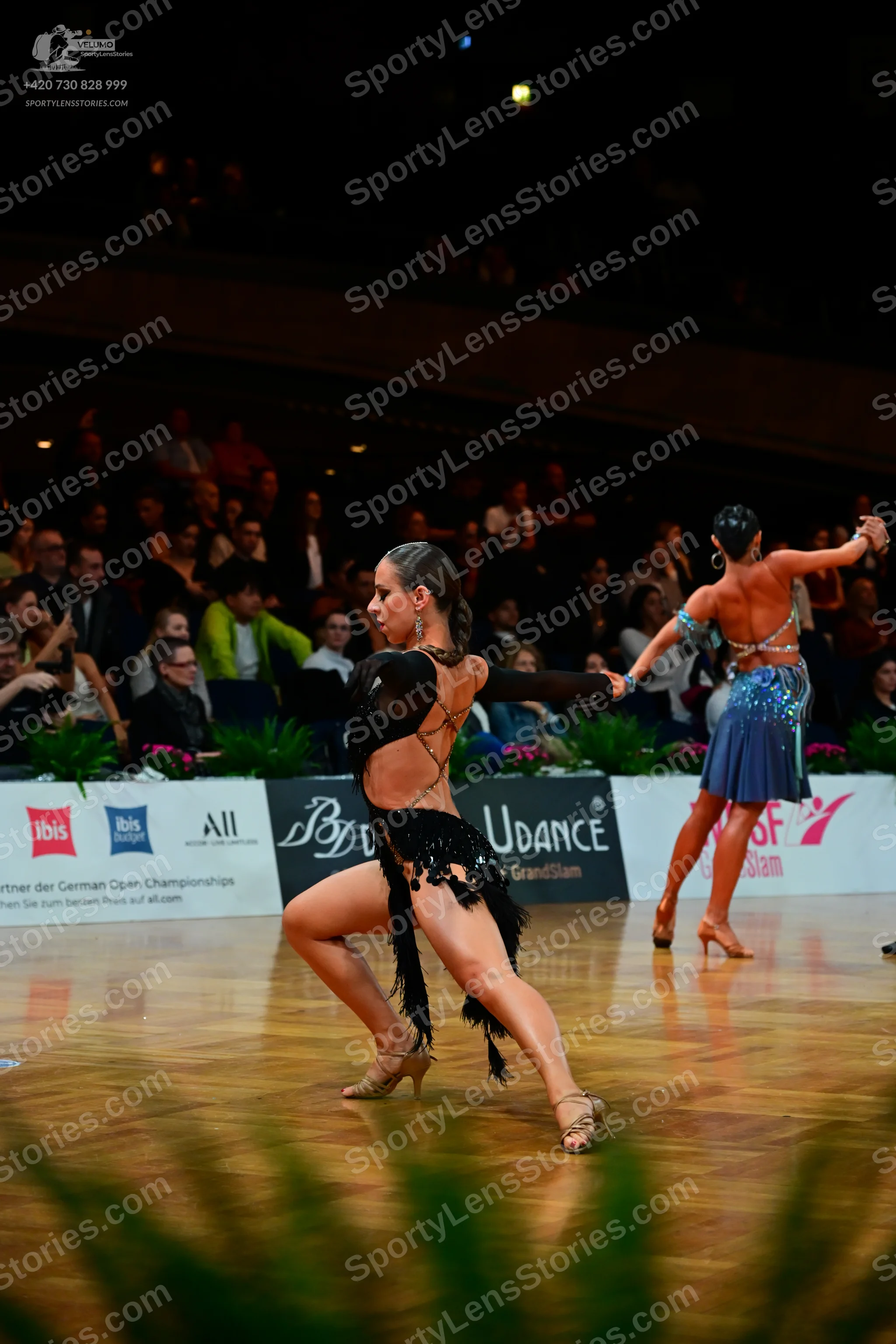 Dancesport competitor: Female dancer 1: black latin dress with sequins and fringe