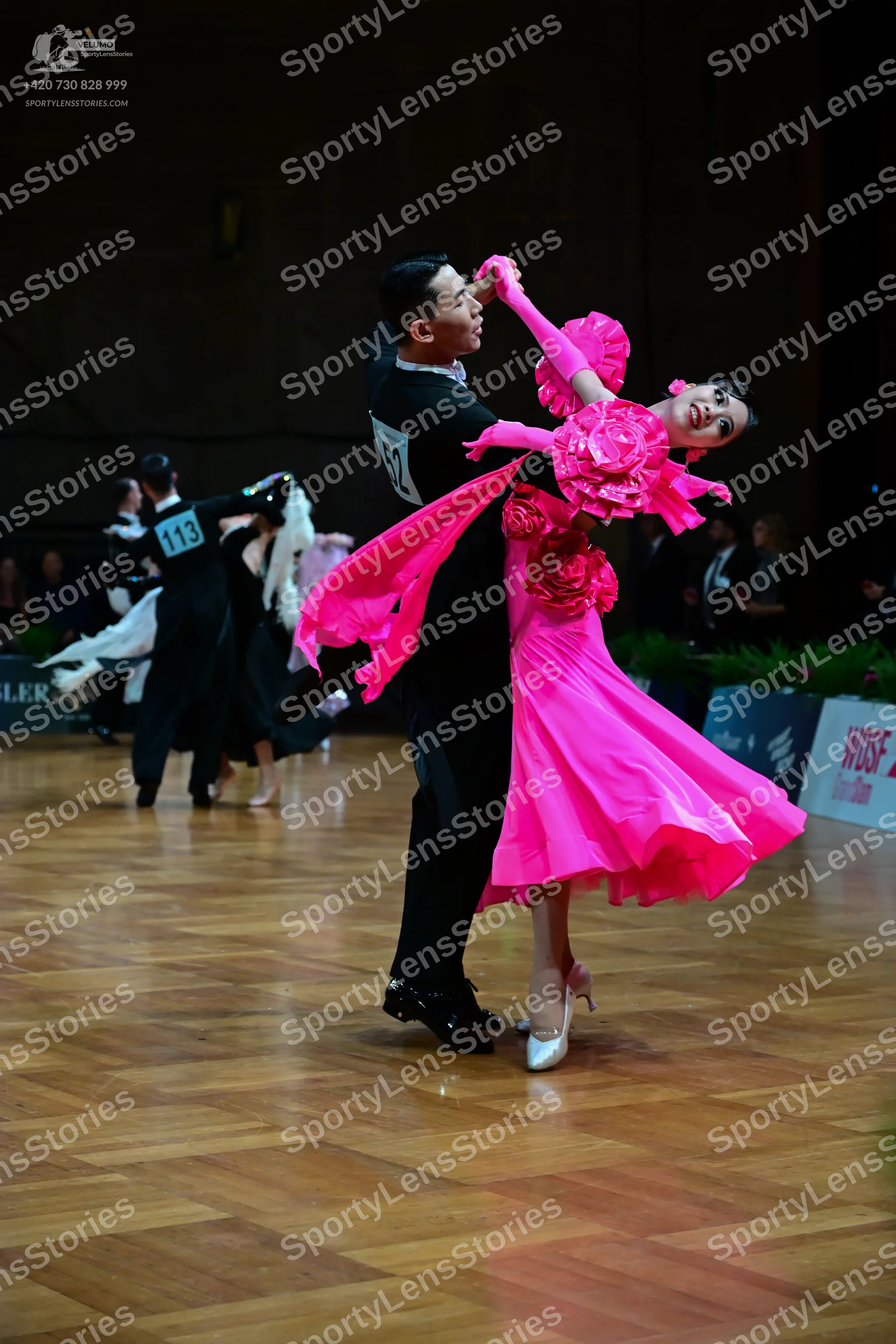 Dancesport competitor #62, #113: Male dancer (foreground): black dance suit