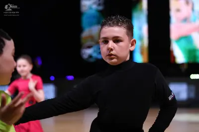 Dancesport competitor: Male dancer: black long-sleeved tight-fitting top