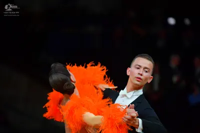 Dancesport competitor: Male dancer: black suit with a white shirt and white bowtie