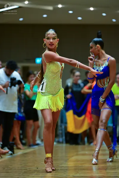 Dancesport competitor: Female dancer 1: bright yellow/lime green latin dance dress with sequins and fri