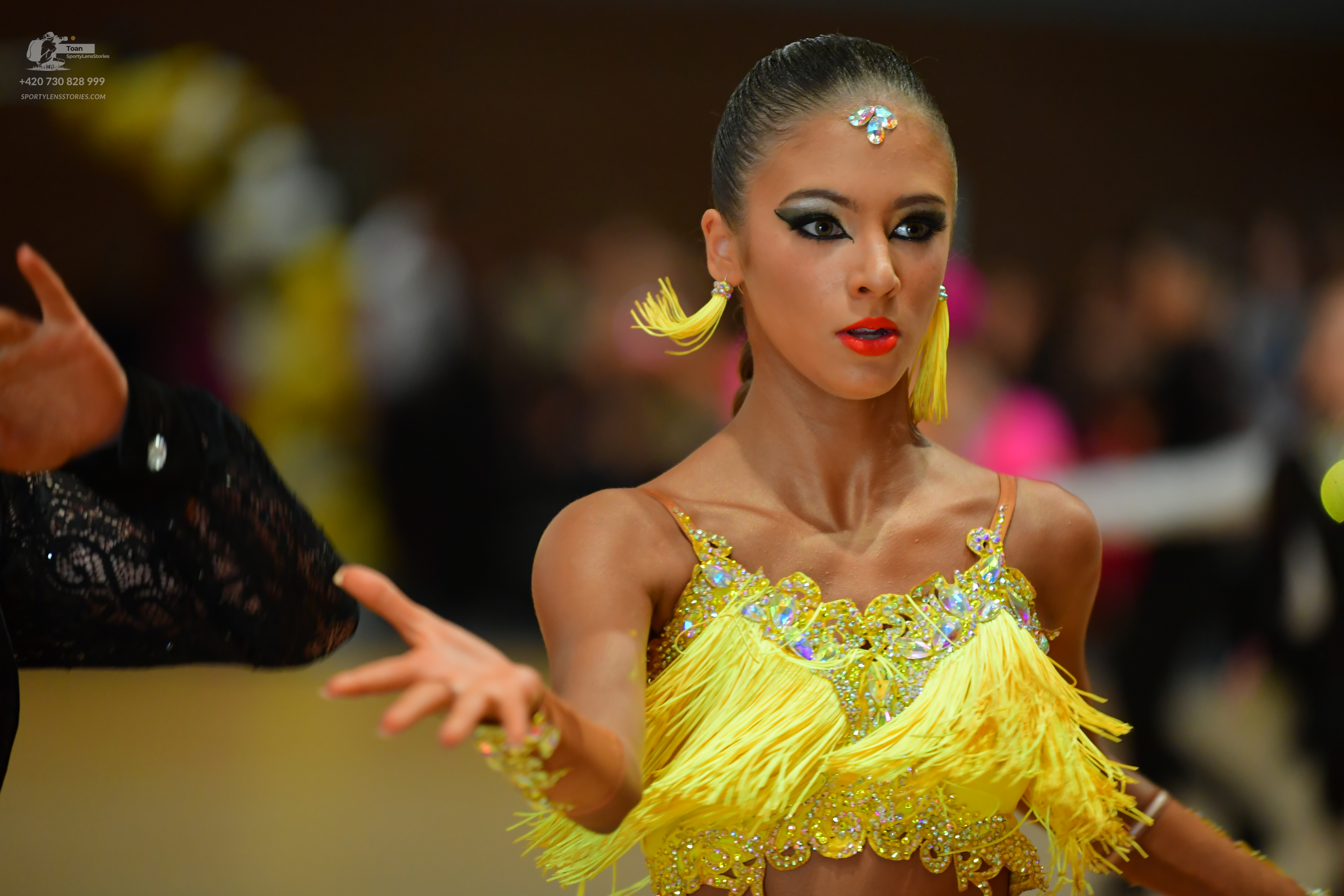 Dancesport competitor: ** Yellow latin dress
*   **Color:** Bright yellow
*   **Fabric:** Sequins and p