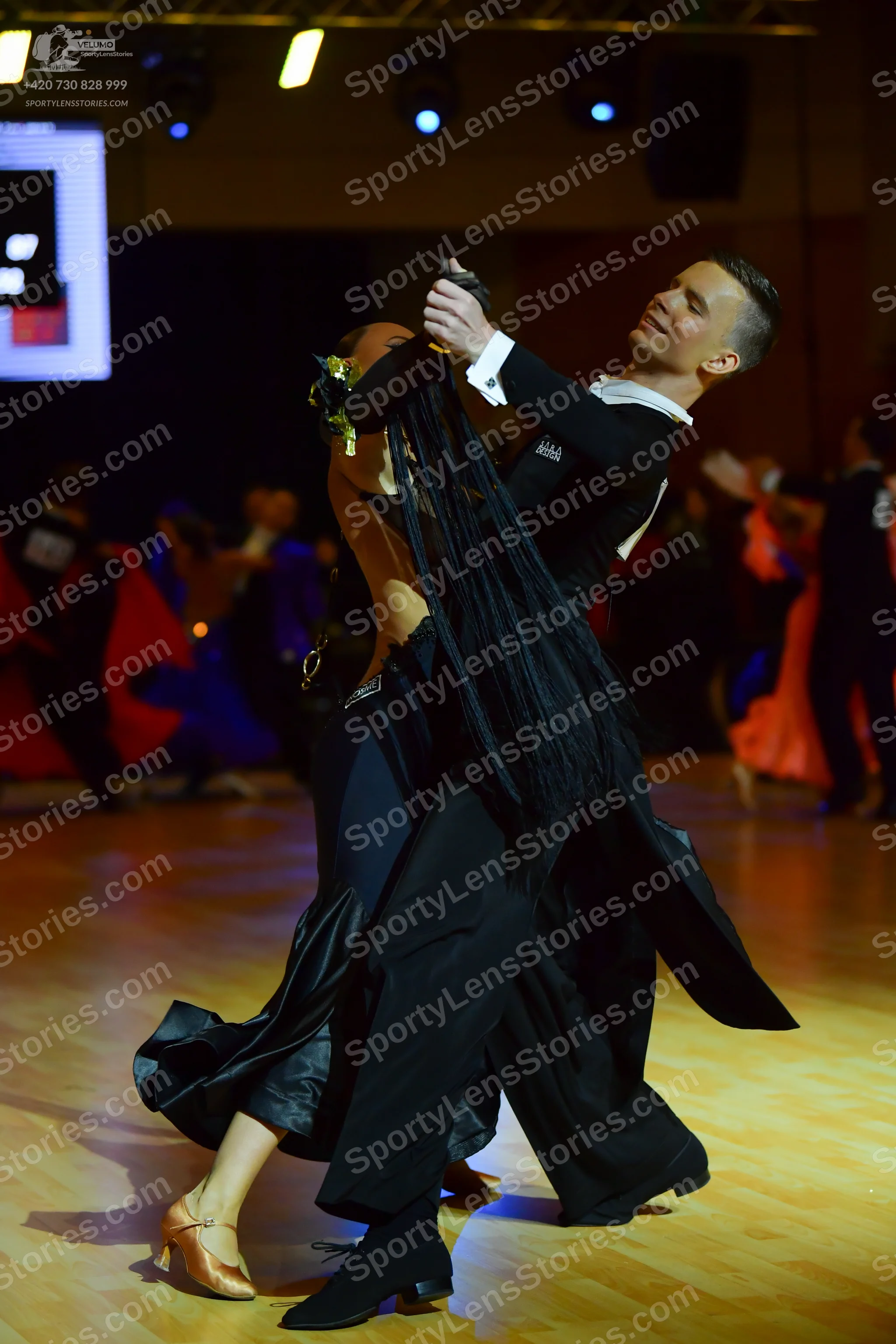 Dancesport competitor: Male dancer: black long-sleeved top with white cuffs