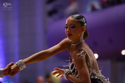 Dancesport competitor: Female dancer: black Latin dance costume with silver sequin and crystal embellis