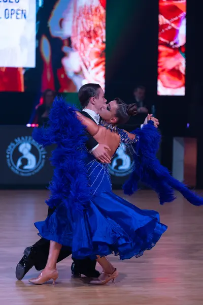 Dancesport competitor: Male dancer: black suit, white shirt, and black bow tie