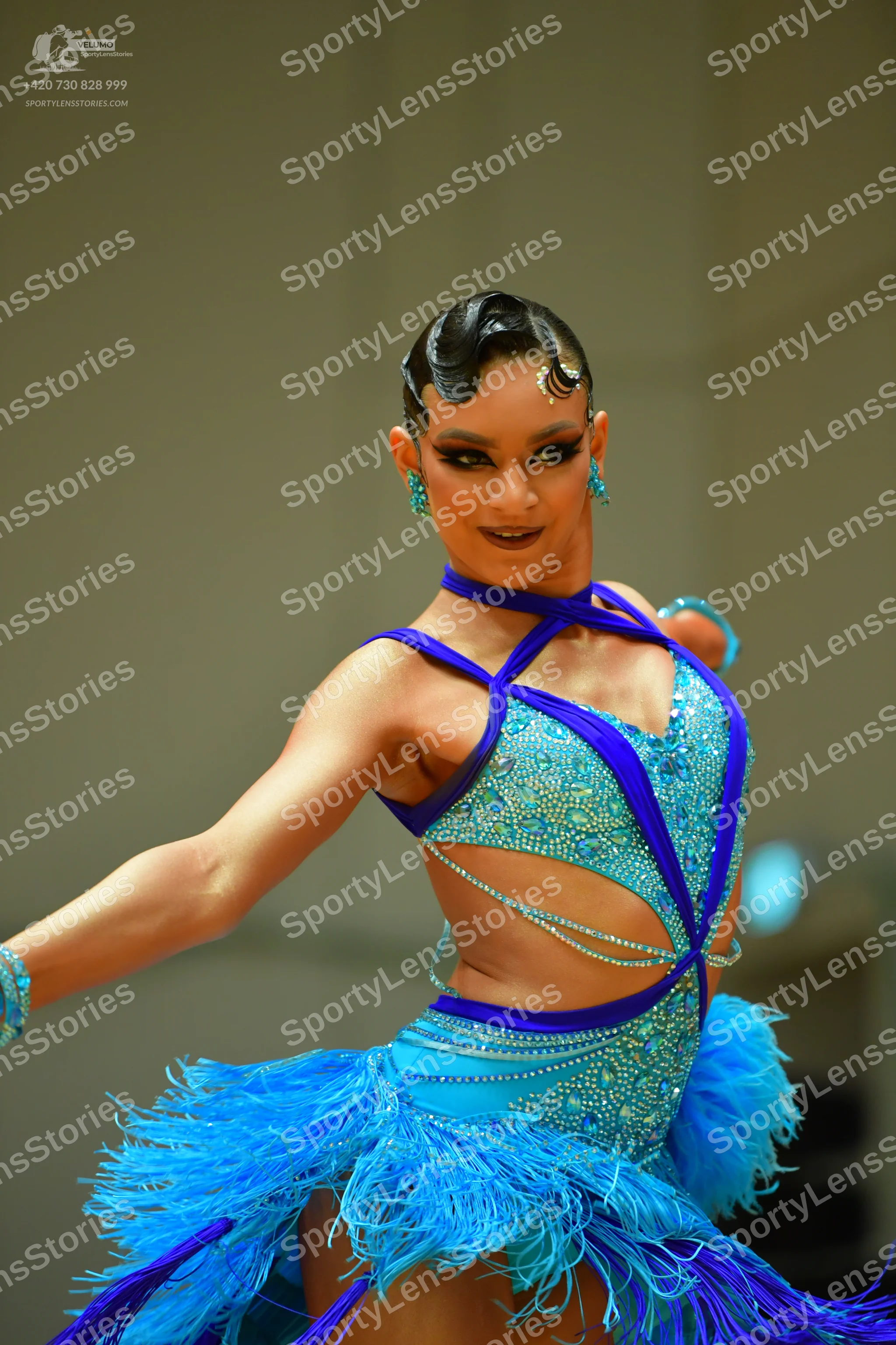 Dancesport competitor: Female dancer: light blue Latin dance dress with dark blue trim, embellished wit