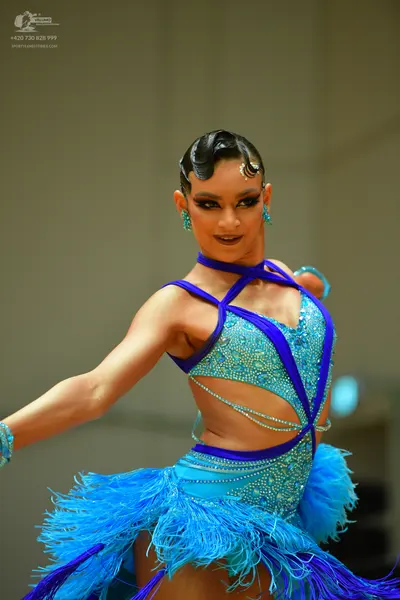 Dancesport competitor: Female dancer: light blue Latin dance dress with dark blue trim, embellished wit