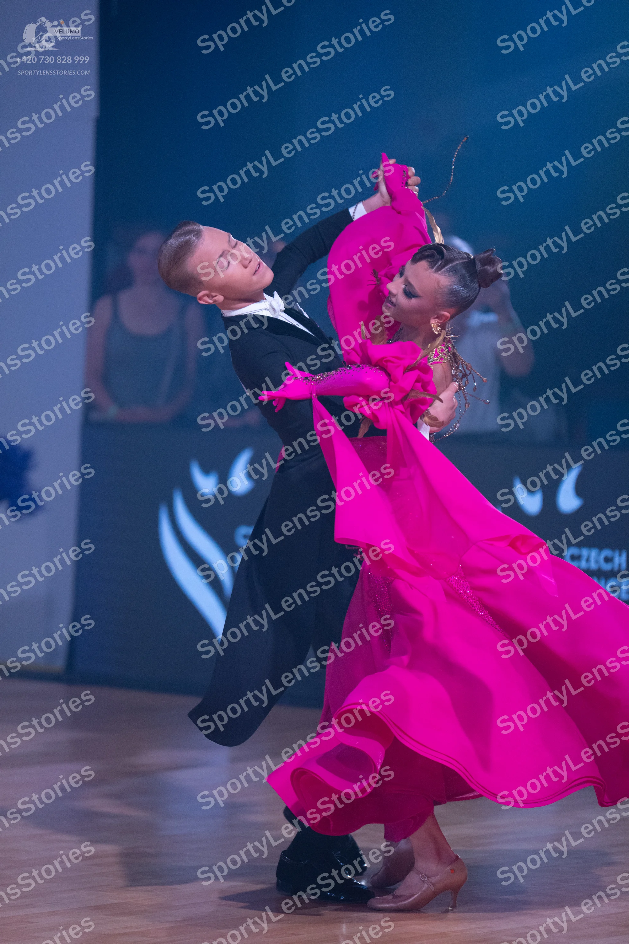 Dancesport competitor: Male dancer: black formal suit with a white shirt and white bowtie