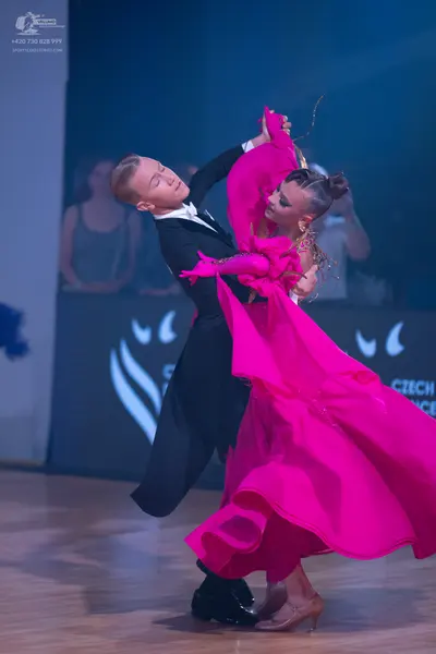 Dancesport competitor: Male dancer: black formal suit with a white shirt and white bowtie
