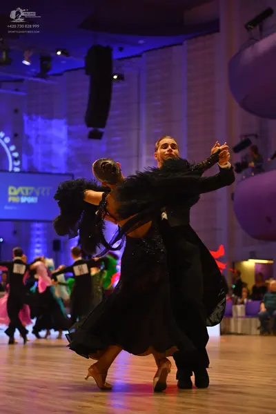 Dancesport competitor: Male dancer: black ballroom tailcoat suit with a white shirt and black bow tie