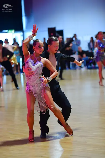 Dancesport competitor: Female dancer: silver/lilac Latin dance dress embellished with sequins and cryst