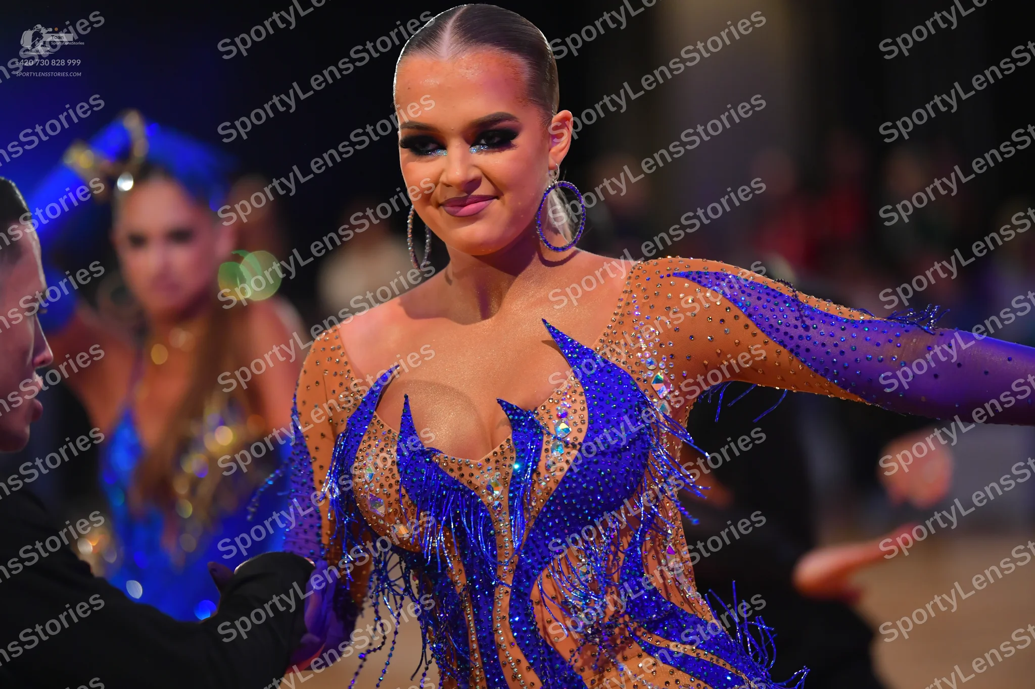 Dancesport competitor: Male dancer in foreground: black suit
