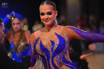 Dancesport competitor: Male dancer in foreground: black suit