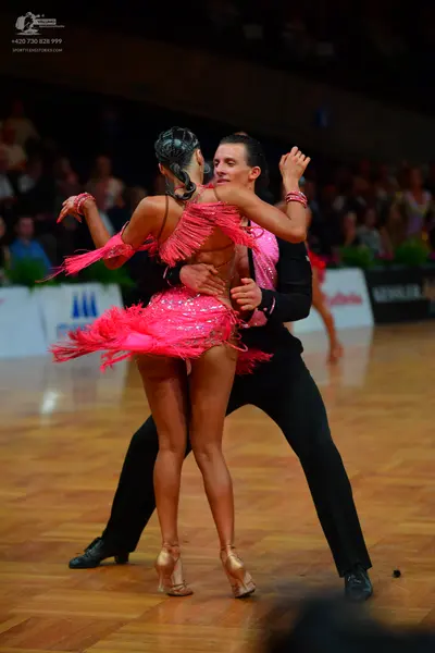 Dancesport competitor: Male dancer: black long-sleeved shirt and black trousers