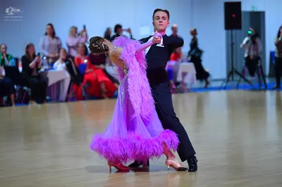 Dancesport competitor: Male dancer: dark navy or black long-sleeved dance shirt and matching trousers
