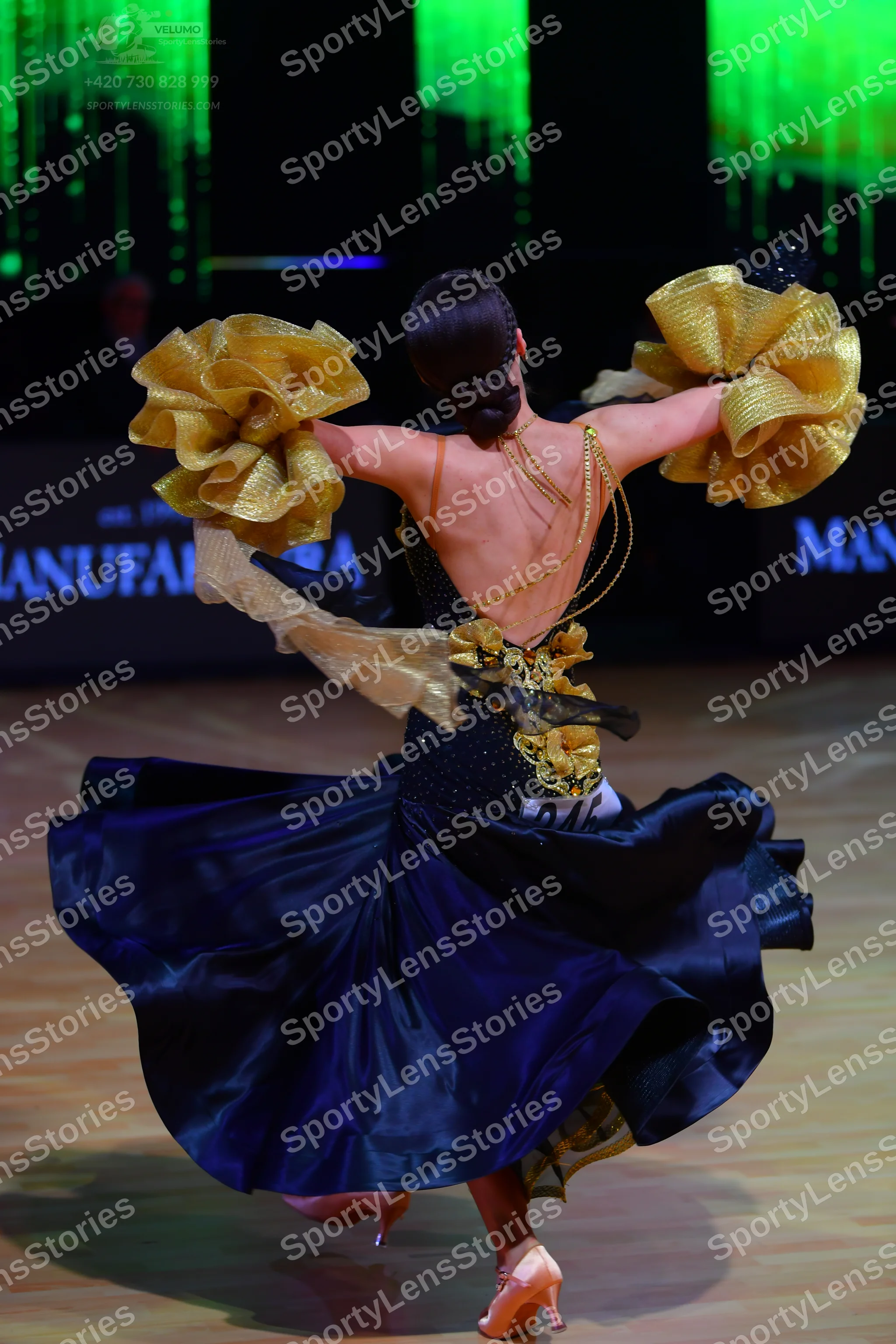 Dancesport competitor: Female dancer: Navy blue ballgown with voluminous satin skirt, featuring large g