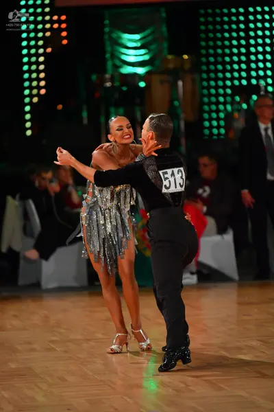 Dancesport competitor #513: Male dancer: black long-sleeved shirt and black trousers