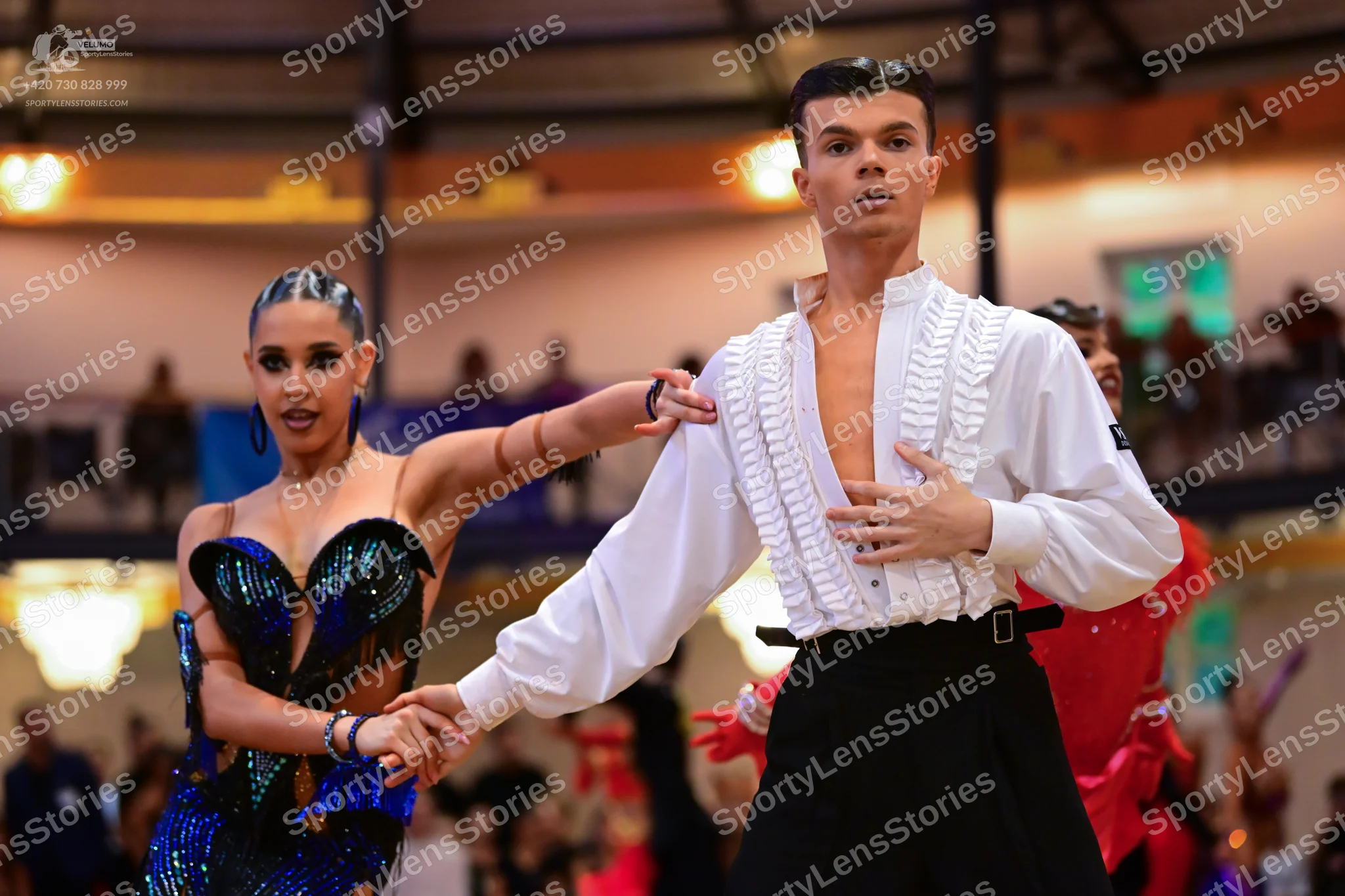 Dancesport competitor: Female dancer: dark blue and black sequin latin dress with a sweetheart neckline