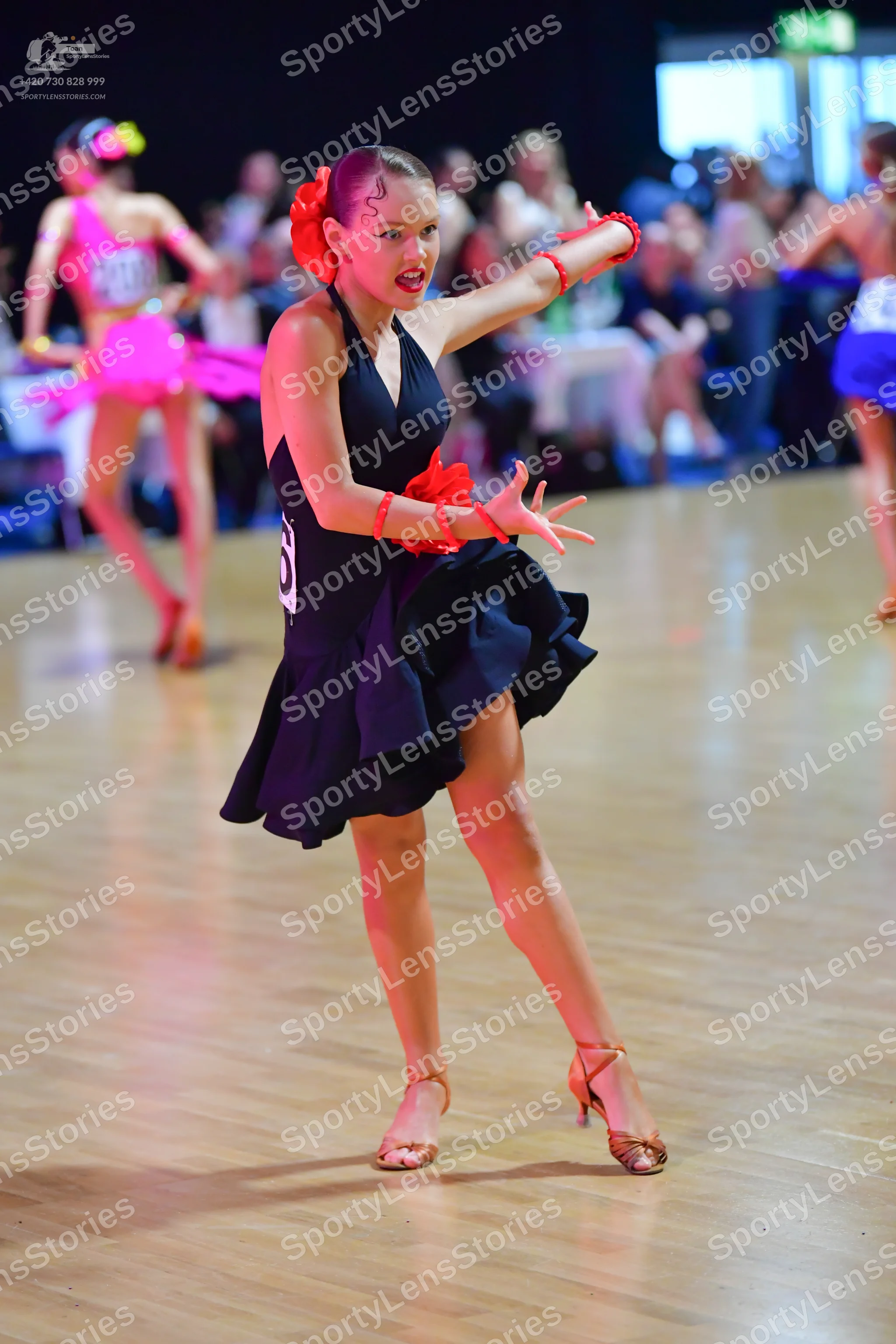 Dancesport competitor #20: Female dancer: black Latin dress with a halter neck and a flared skirt, accessor